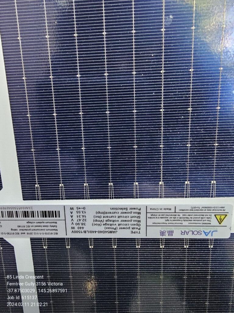 Close-up of a JA Solar panel with installation details including location and job ID.