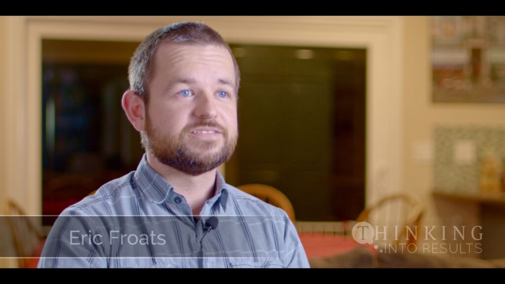 Eric Froats speaking about his experience with the Thinking Into Results program, seated in a kitchen or dining area.