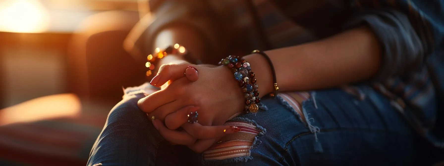 a person wearing a gemstone bracelet, looking calm and relaxed.