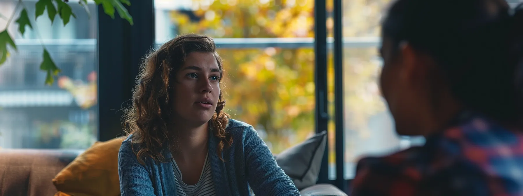 a person sitting across from a local mindset coach during a face-to-face session.