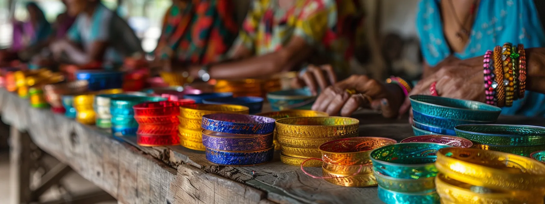 a group of artisanal miners in a fair trade gemstone workshop, with brightly colored bangles displayed on a table.