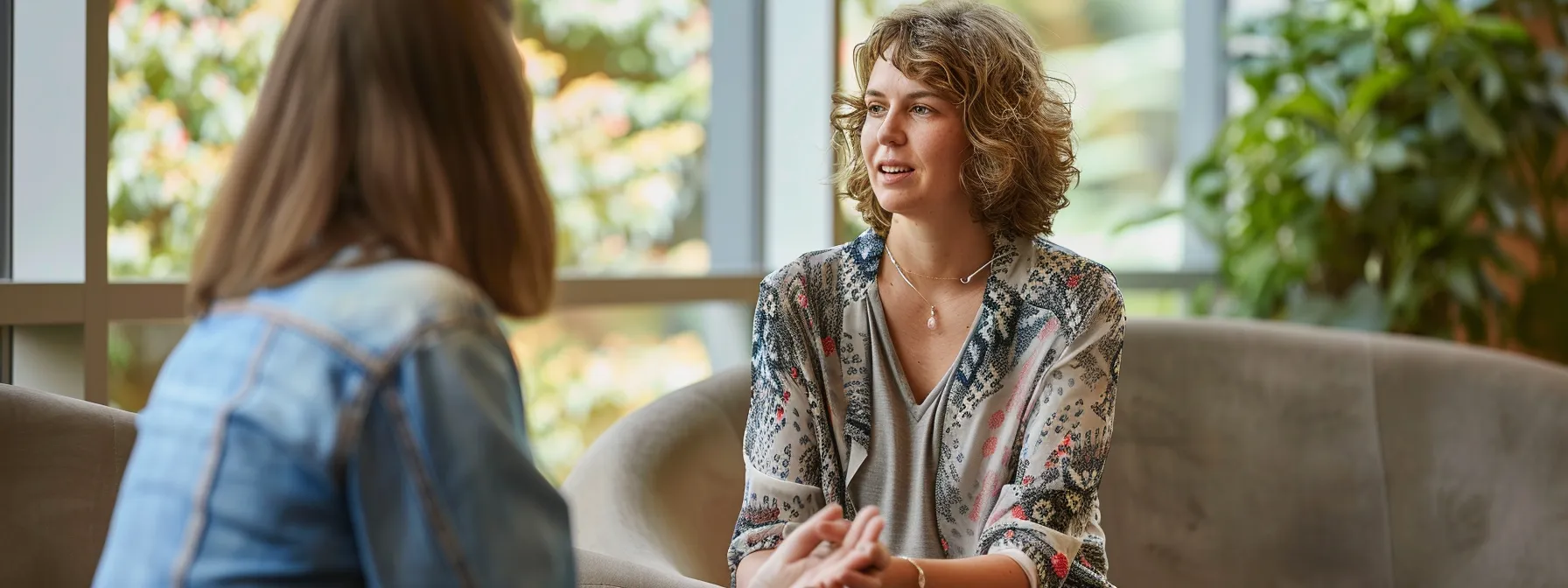 a healthcare practitioner and client engaging in a deep conversation during a session, surrounded by calming and nurturing surroundings.