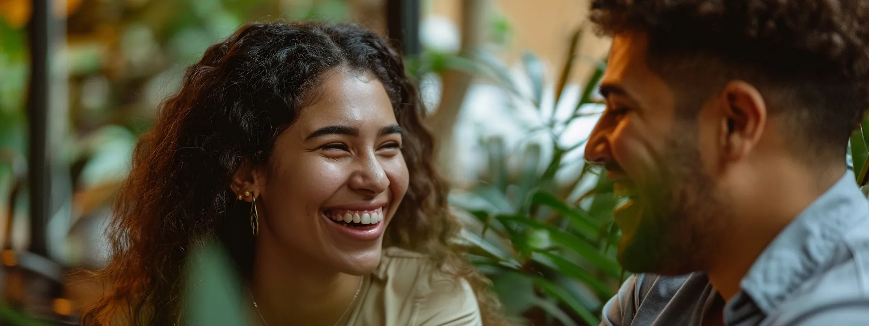 a couple embracing and smiling at each other during a therapy session.