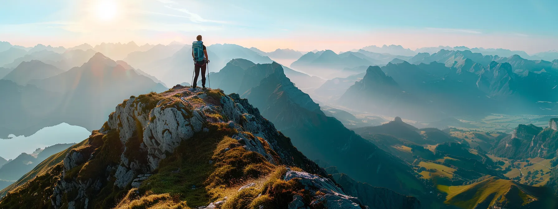 a person standing confidently on top of a mountain peak, symbolizing overcoming limitations with psych-k.