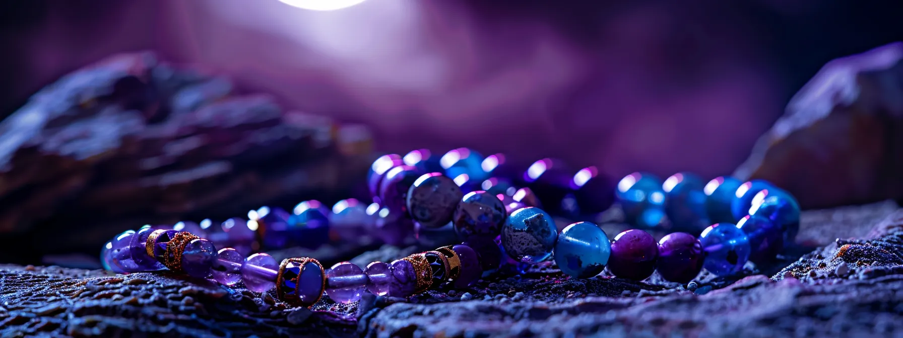 gemstone bracelets laid out under the glow of the full moon, surrounded by vibrant violet hues and sparkling in the moonlight.