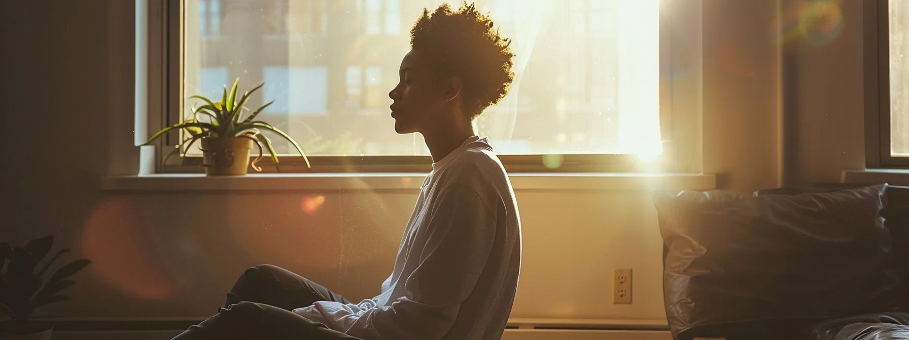 a person sitting in a peaceful room, with a serene expression on their face as they visualize their goals and dreams.