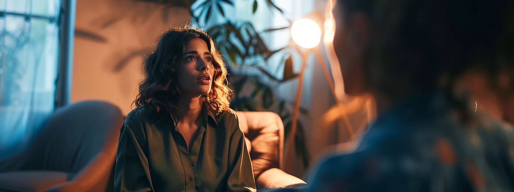 a person sitting across from a mindset coach, engaged in deep conversation and reflection.