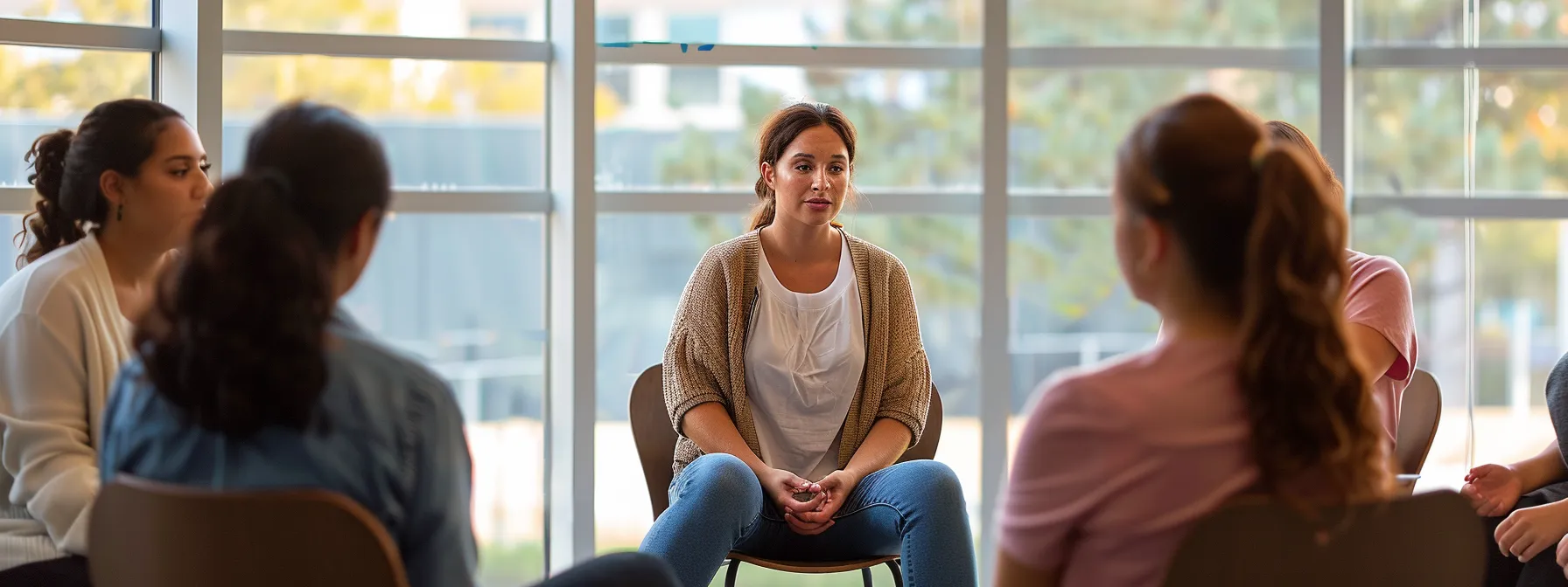 psych-k practitioner leading a group therapy session with participants reflecting on their emotional responses.