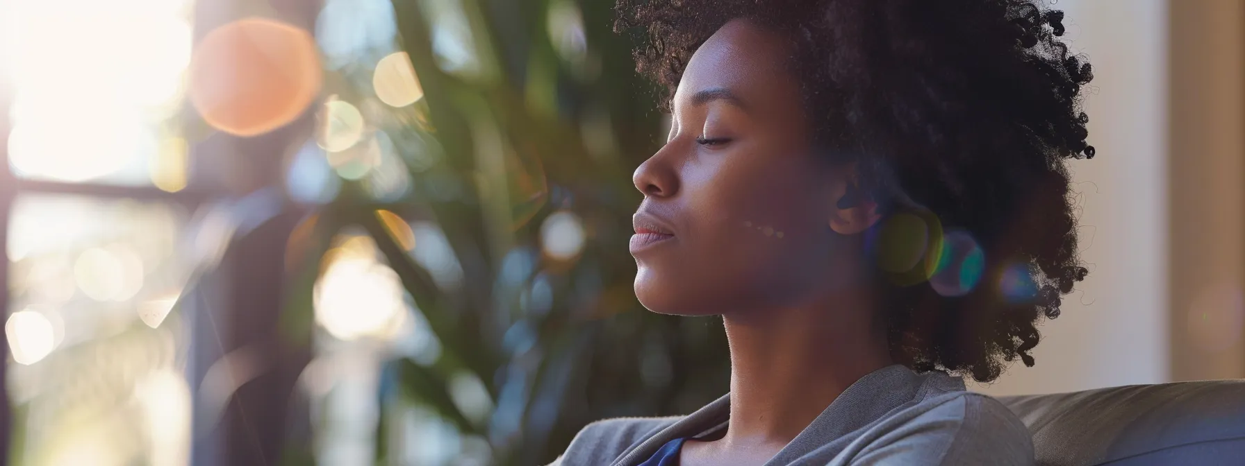 a person sitting in a therapy session, deep in thought with a focused expression on their face.