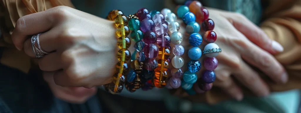 a person wearing various colorful gemstone bracelets on their wrist.