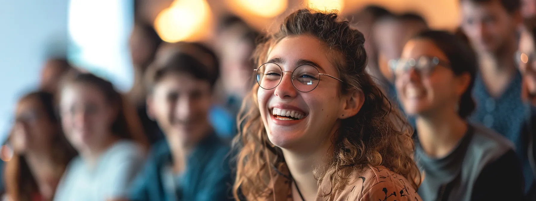 a person smiling confidently, talking in front of a cheering crowd at a public speaking event.