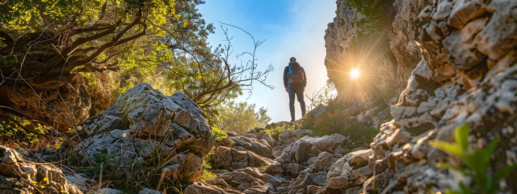 a person standing confidently on a rocky path, looking forward with determination.