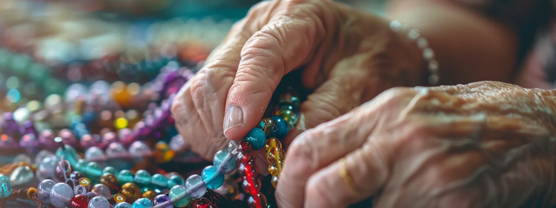 hands selecting colorful beads and wire for a custom birthstone bracelet.