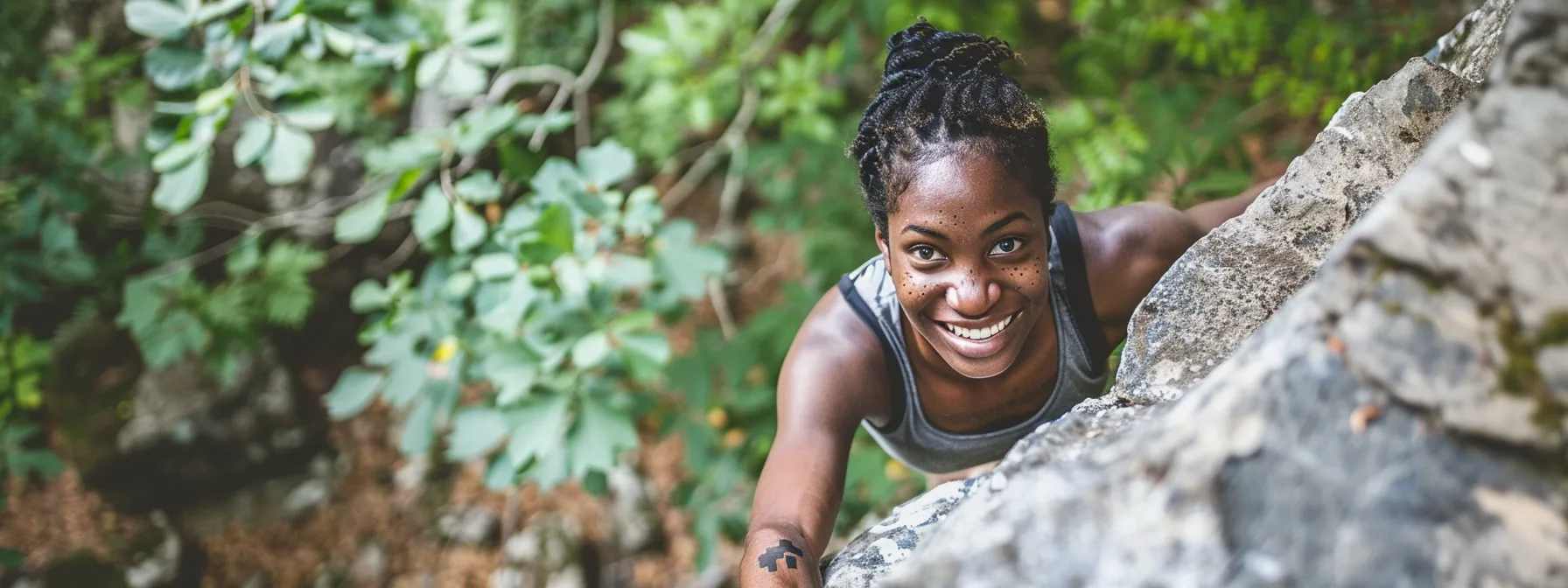 a determined individual smiling while climbing over a large rock, symbolizing overcoming obstacles with a positive attitude.