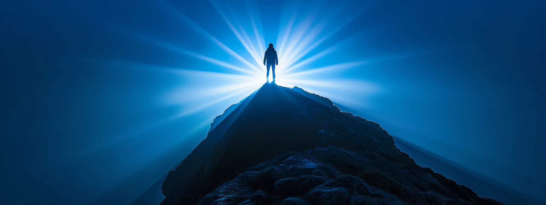 a person standing confidently on a mountain peak, with beams of light shining down on them, surrounded by a glowing aura of success and determination.