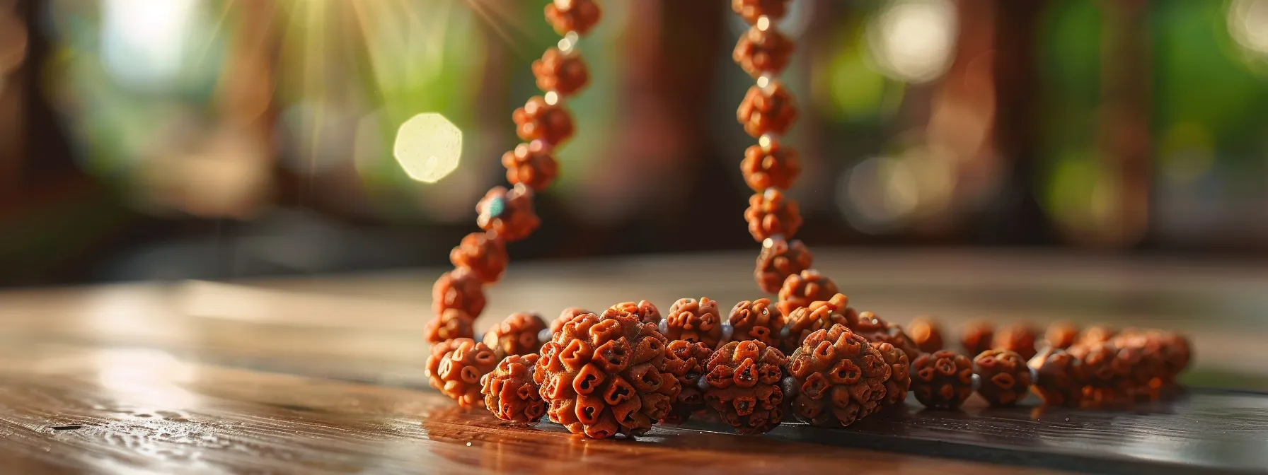 a close-up photo of a rudraksha bead necklace hanging on a wooden altar, radiating a serene and sacred energy.