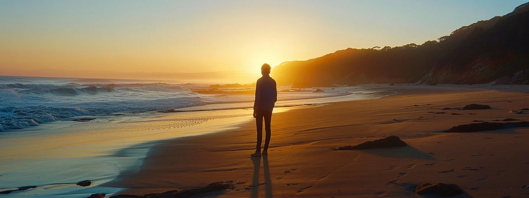 a confident individual visualizing success on a stunning australian beach at sunrise.