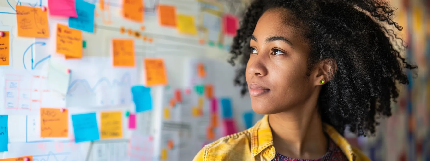 a focused individual brainstorming ideas on a whiteboard, surrounded by colorful sticky notes and charts, illustrating strategic problem-solving in action.