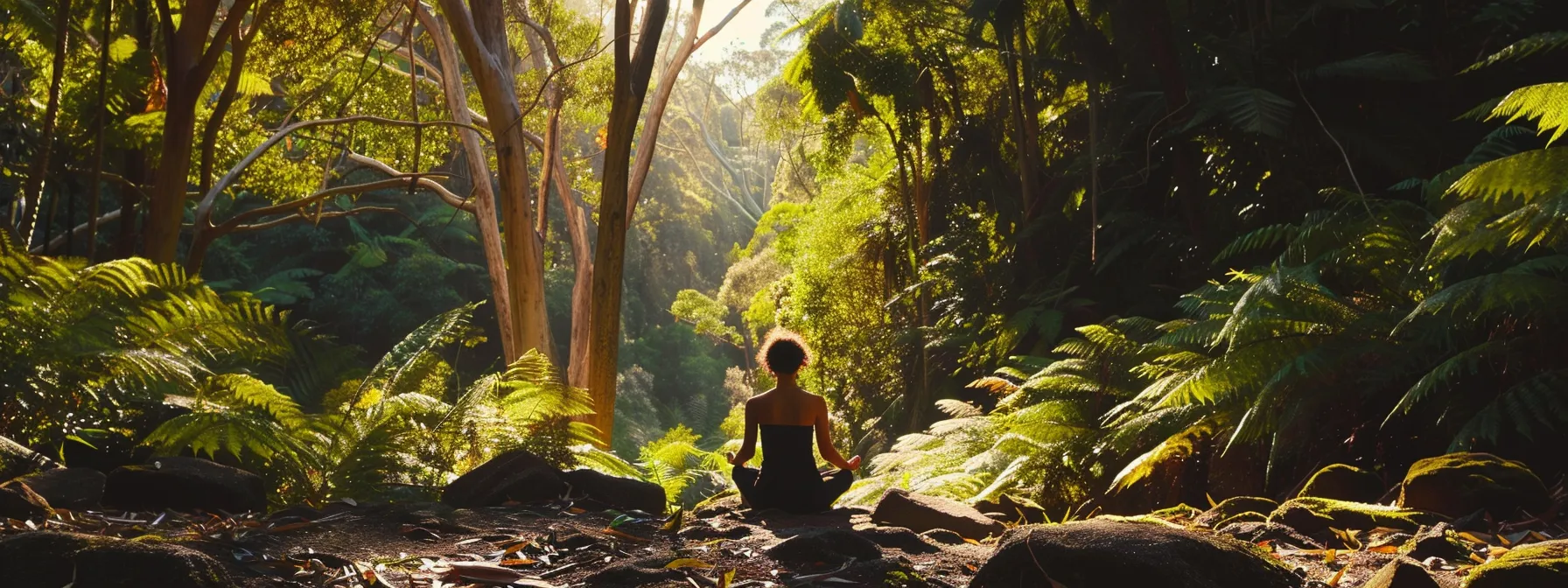 a person meditating in a lush australian forest, surrounded by a perfect balance of vibrant masculine and feminine energies.