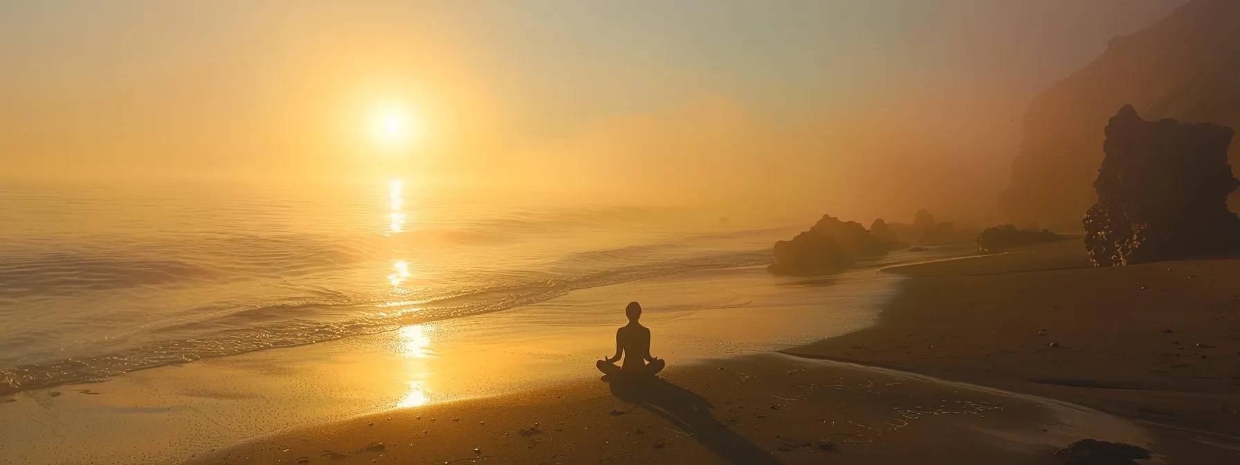 a person meditating on a tranquil beach at sunrise, surrounded by positive energy and inner peace.