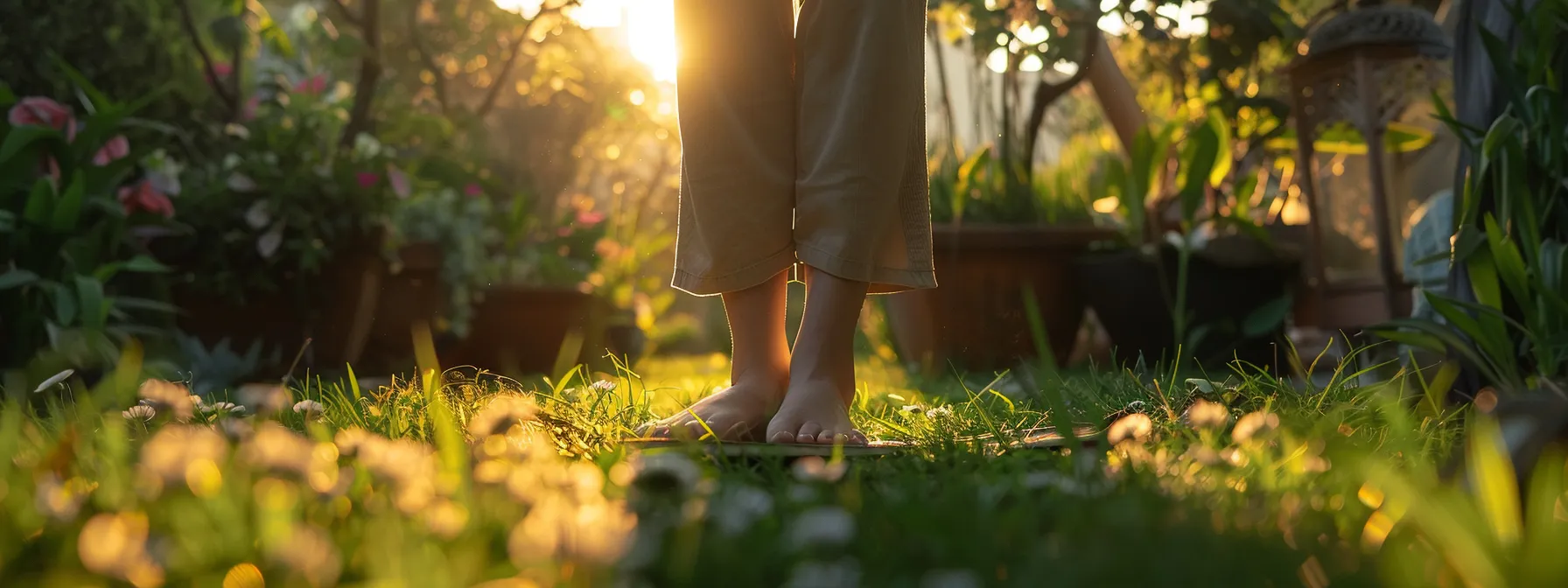 a person practicing grounding yoga poses barefoot on grass in a serene outdoor setting.