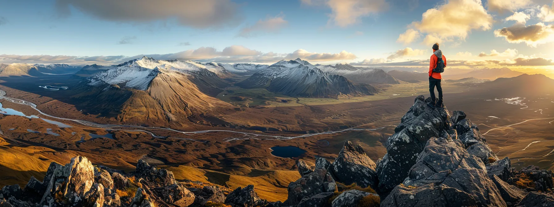 a person standing confidently at the summit of a mountain, gazing out at a vast, inspiring landscape.