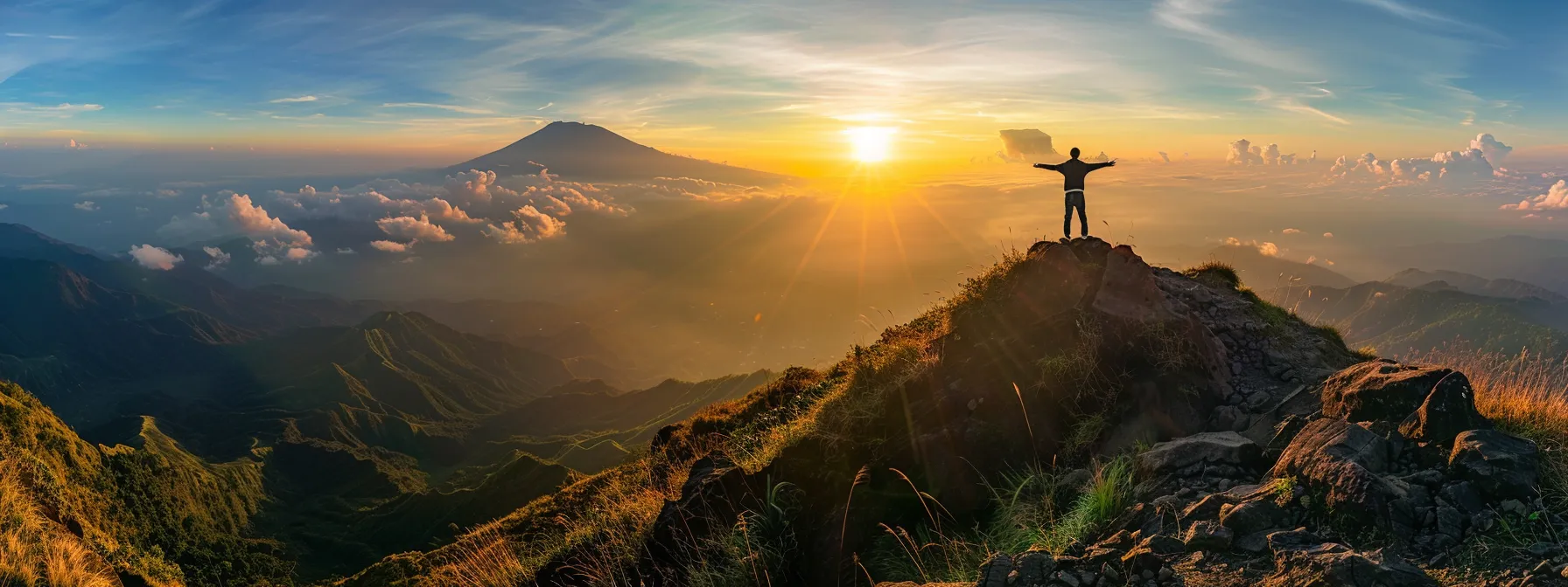 a person standing confidently on top of a mountain, arms outstretched, basking in the glow of a beautiful sunrise.