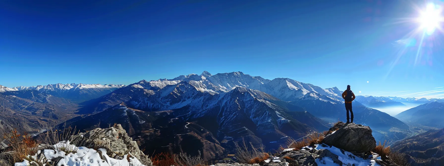 a person standing confidently on top of a mountain, surrounded by clear blue skies and breathtaking views, symbolizing empowerment and personal growth through belief change and mindset shifts with psych-k techniques.