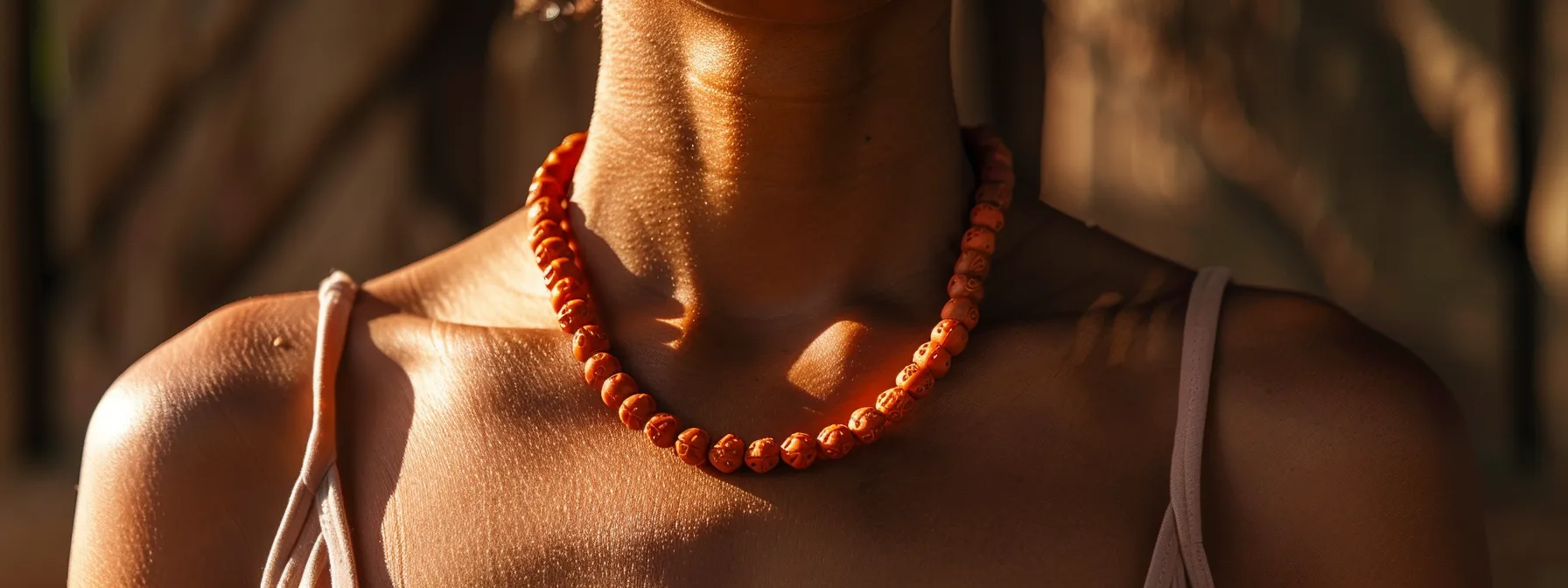 a person wearing a ten mukhi rudraksha necklace with a serene expression, symbolizing a strong spiritual connection and inner peace.