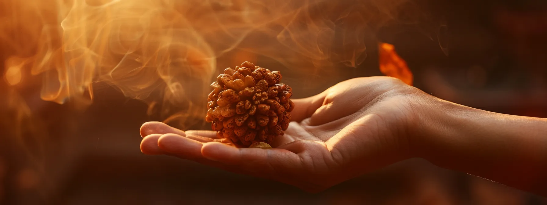 a serene hand holding a gleaming ten mukhi rudraksha, surrounded by soft light and a faint hint of sandalwood incense.