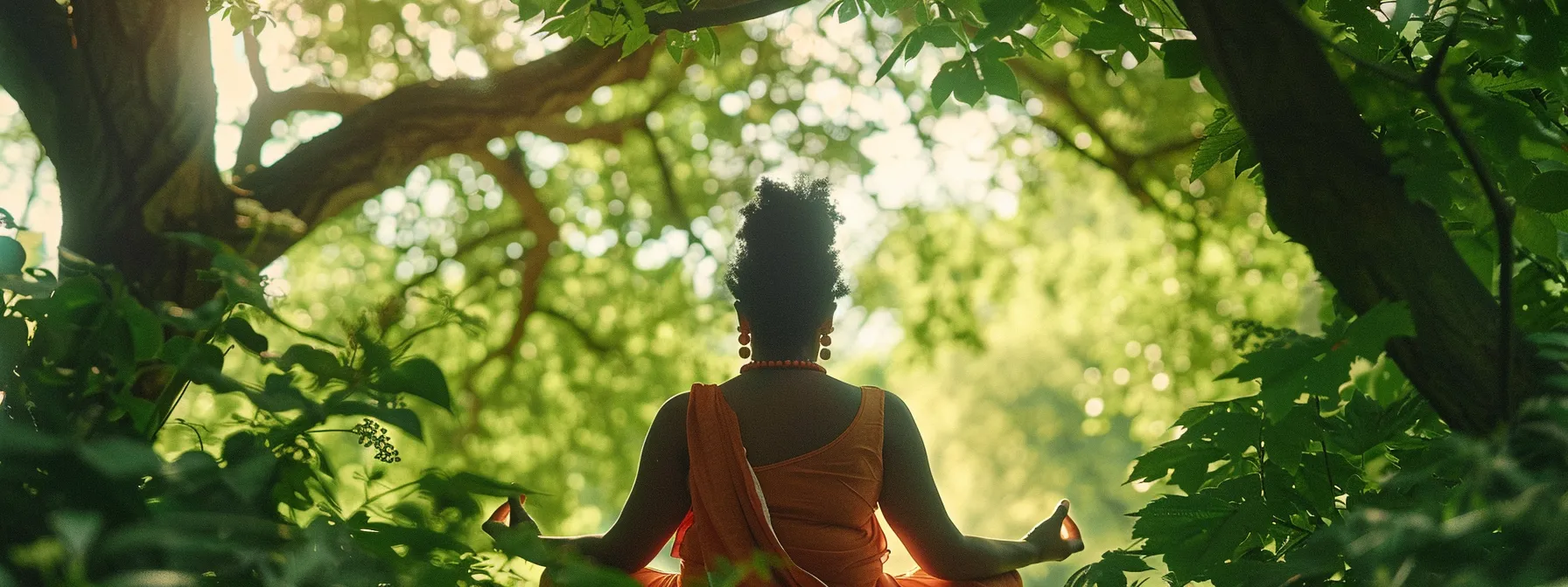 a serene person meditating under a canopy of lush green trees while wearing a ten mukhi rudraksha necklace.