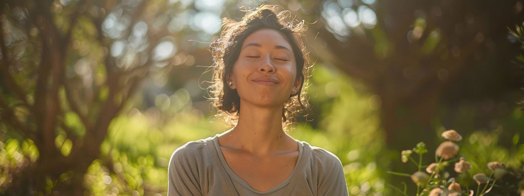 a smiling individual engaging in a heart coherence practice in a serene natural setting, showcasing the power of improving wellness through hrv analysis.