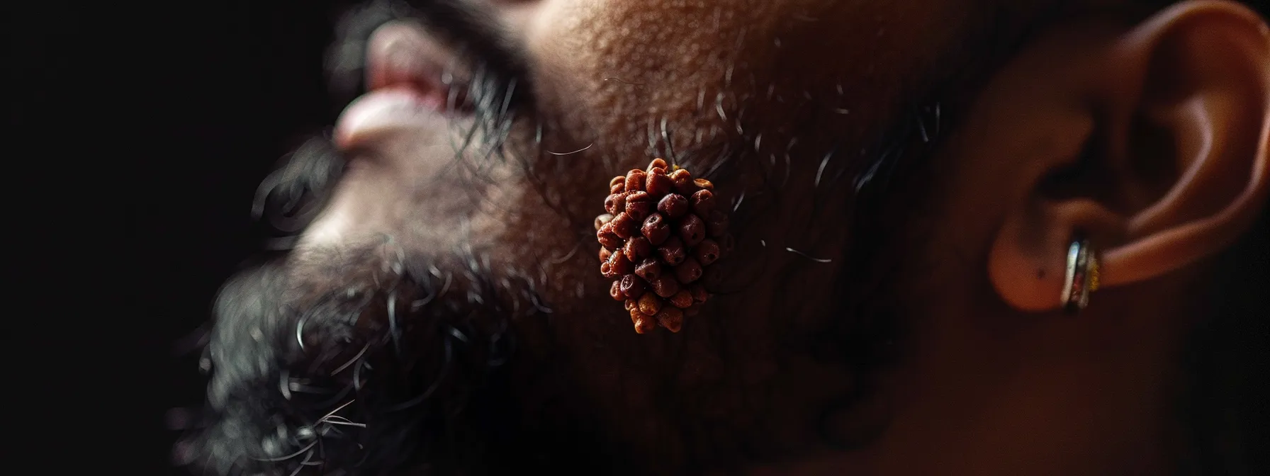 a close-up shot of a confident individual wearing a twelve mukhi rudraksha bead, exuding a strong aura of leadership and assertiveness.