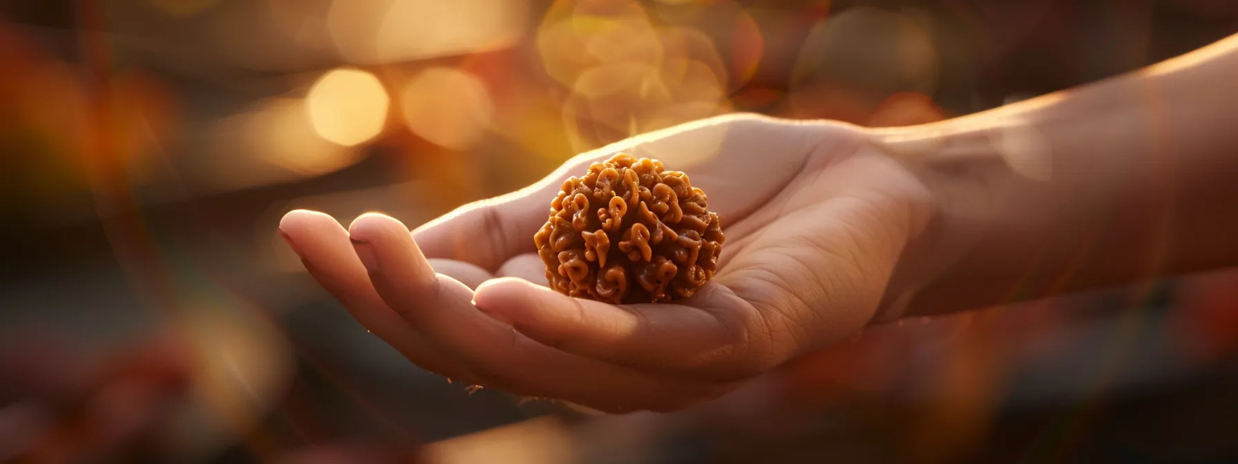 a serene hand holding a shimmering thirteen mukhi rudraksha bead, surrounded by soft lighting to highlight its spiritual energy and significance.