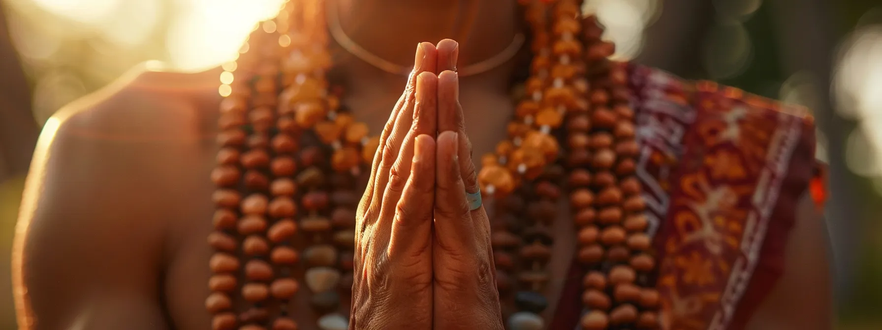 a close-up photo of a person meditating with a serene expression, wearing a beautiful rudraksha necklace, symbolizing spiritual growth and enlightenment.